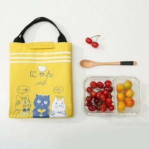 Top view of yellow canvas lunch bag with cartoon cats and insulated foil lining