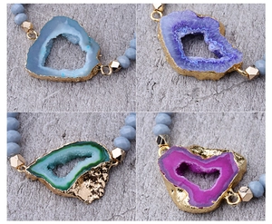 Macro shot of faceted crystal beads and colorful druzy agate slices with gold plating