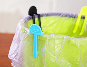 Detail shot of plastic clips fixing garbage bags onto trash cans in multiple colors