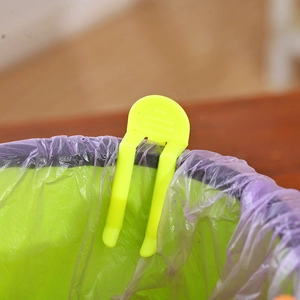 Bright yellow plastic trash bag clip fastener for securing bags on waste bins