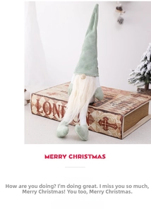 Detailed view of a green Nordic Christmas gnome doll with white beard on vintage wood box