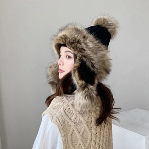 Women's black knitted aviator hat with thick brown faux fur ear flaps and pom-pom