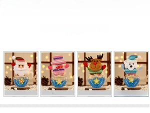 Detail view of 4 Christmas candy jars featuring Santa, Snowman, Reindeer, and Bear designs