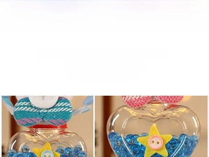 Detail of heart-shaped Christmas candy jar with glitter bow and blue decorative beads