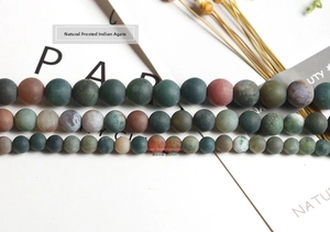 Macro shot of multi-color matte Indian Agate beads in three sizes for DIY jewelry