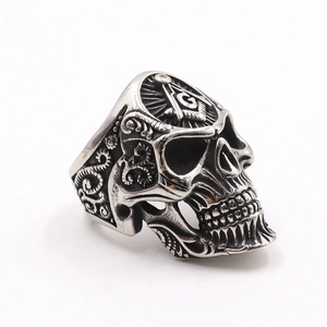 Detail of vintage punk skull ring in stainless steel with Masonic symbol engraving