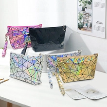 Detailed view of four geometric laser reflective clutches in pink, black, gold and silver