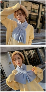 Detail of light blue plush scarf with criss-cross design and soft furry texture