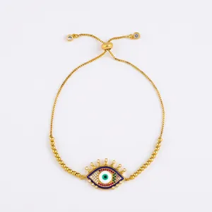 Adjustable evil eye gold bracelet featuring multi-color gemstones and a slide closure