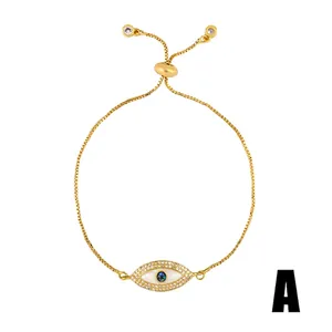 Detailed shot of golden evil eye bracelet with blue opal center and zircon stones