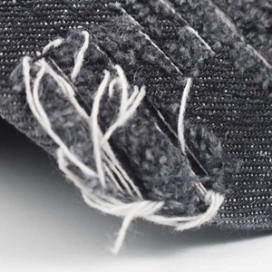 Distressed dark denim baseball cap featuring vintage frayed edges and premium twill texture