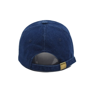Detail of navy denim docker hat featuring vintage metal buckle and adjustable strap