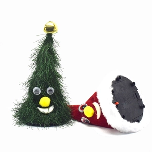 Close-up of animated Christmas tree and hat plush toys with battery base detail