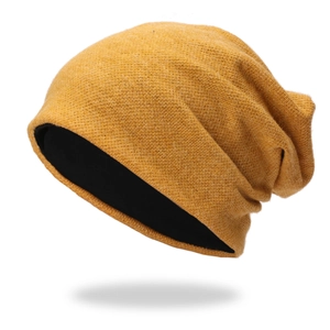 Detailed close-up of ginger yellow slouchy beanie with warm black thermal lining