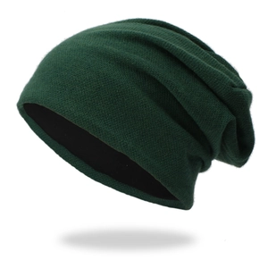 Detail of dark green knitted slouchy beanie with thick texture and black lining