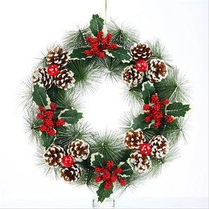 Christmas pine needle wreath with snowy pine cones, red berries and dotted ornaments