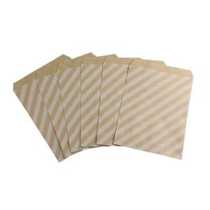 Detail of brown kraft paper gift bags with white diagonal stripes for party treats