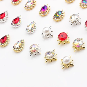 Macro shot of colorful K9 crystal nail charms in alloy settings with pearls