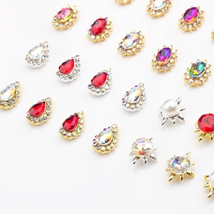 Macro detail of mixed-shape K9 colorful crystals with gold and silver metal alloy settings