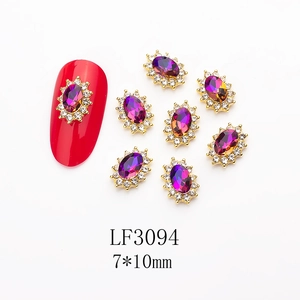 Detail of purple oval nail art rhinestones with white zircon border and gold metal base