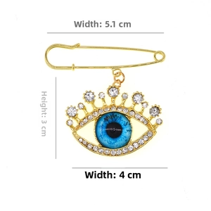 Detailed size view of gold Evil Eye brooch pin with blue crystals and white rhinestones