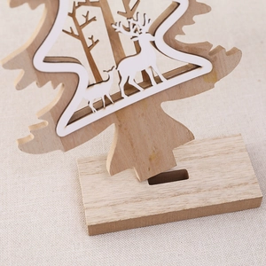 Handcrafted wooden Christmas tree decoration with laser-cut deer and forest motif