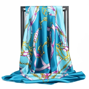 Classic blue silk square scarf with gold equestrian chain and bit print on white rack