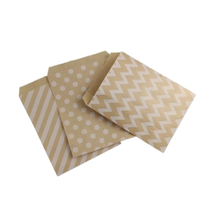 Eco-friendly kraft paper bags with white stripe, polka dot and wave patterns on white background