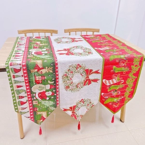 Close-up of Christmas table runners with jacquard patterns and tassel pendant details