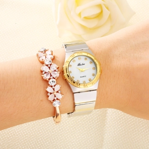 Elegant gold and silver quartz watch with rhinestone markers and matching floral bracelet
