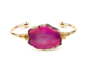 Macro detail of hand-wrapped copper wire and purple druzy agate on gold open cuff bracelet