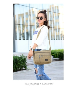 Outdoor shot of a khaki canvas crossbody bag with multi-pocket design and adjustable strap