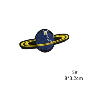 Close-up of Saturn planet embroidery patch with blue threads and yellow ring details