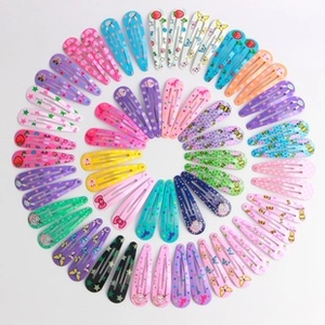 Detailed top view of colorful sequined heart and star pattern metal snap hair clips