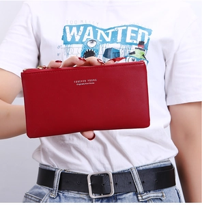 Red leather long zip wallet held by model showing large capacity and stylish design