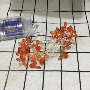 Macro view of elk shaped LED string lights with battery box and clear wires for Christmas