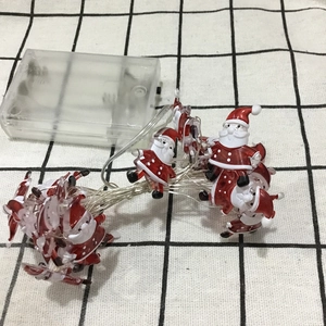 Detailed view of Santa Claus LED string lights with transparent portable battery box
