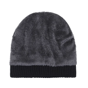 Faux fur winter beanie hat with gray fluffy texture and black ribbed knit cuff for warmth