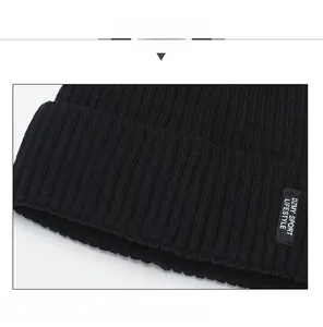 Detail of black ribbed knit beanie showing fine texture and sewn sport lifestyle label