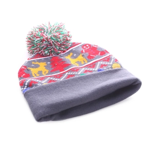 Close-up of LED Christmas knitted beanie featuring festive reindeer and gingerbread motifs