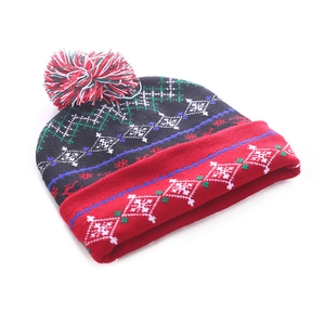 Close-up of LED Christmas beanie with festive snowflake pattern and colorful pom-pom
