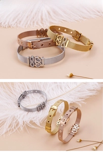 Detailed view of mesh bracelet heart charms in gold, silver and rose gold finishes