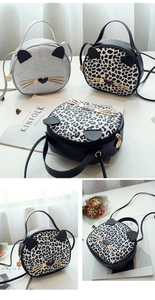 Detail of trendy leopard print cat-shaped handbags with gold whiskers and round metal zippers