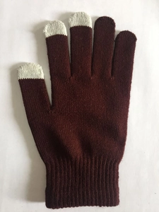 Detail of dark red knit gloves with light grey conductive touch screen fingertips