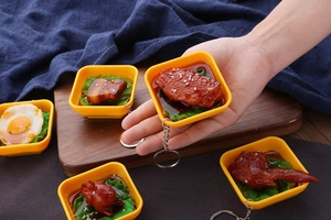 Detailed view of realistic miniature food keychains featuring assorted Chinese dishes