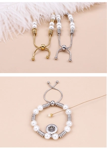 Detail view of adjustable pearl bracelet with tree of life charm in gold and silver