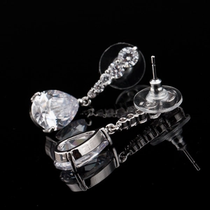 Close-up of silver water-drop earrings featuring round and pear-cut cubic zirconia