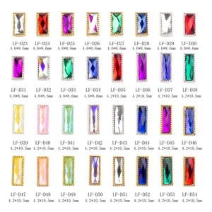 Detail view of rectangular nail gems in 32 colors with gold and silver metal borders