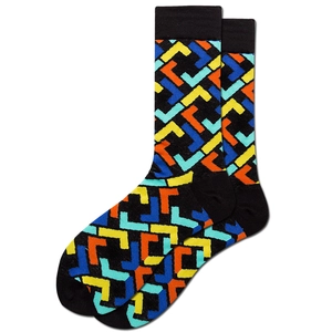 Detail of black knitted crew socks featuring colorful yellow and blue geometric patterns