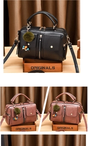 Detail of trendy PU leather pillow bag showing textured finish and multiple zipper pockets